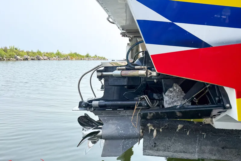Slide: The Image of Rear view of a 2000 Sonic 45 SS boat with colorful hull design. - 13