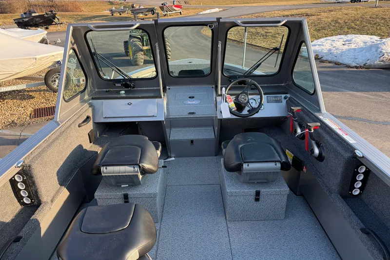 Slide: The Image of 2026 Crestliner 2050 Commander boat interior with steering wheel and seating. - 6