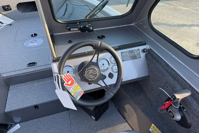Slide: The Image of Interior view of 2026 Crestliner 2050 Commander boat cockpit with steering wheel and controls. - 7