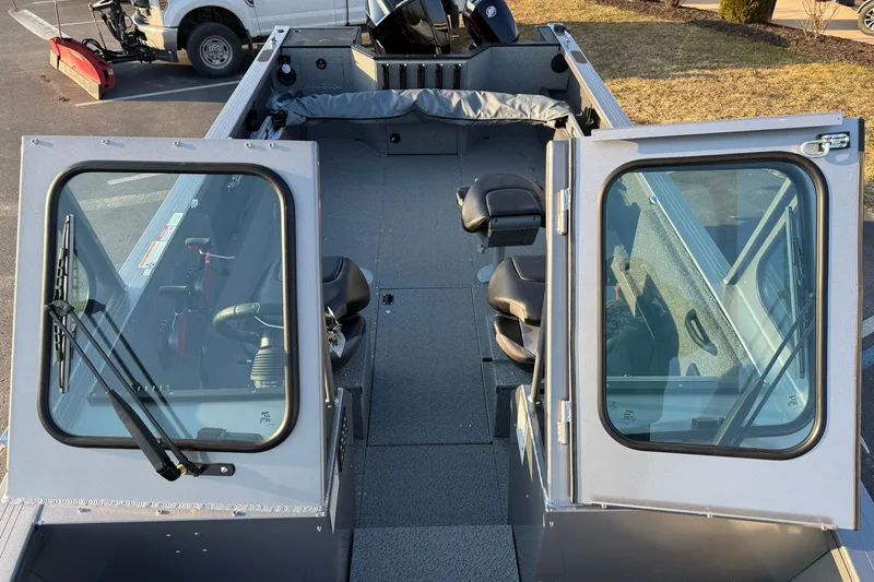 Slide: The Image of 2026 Crestliner 2050 Commander boat interior with seating and windshield view. - 5