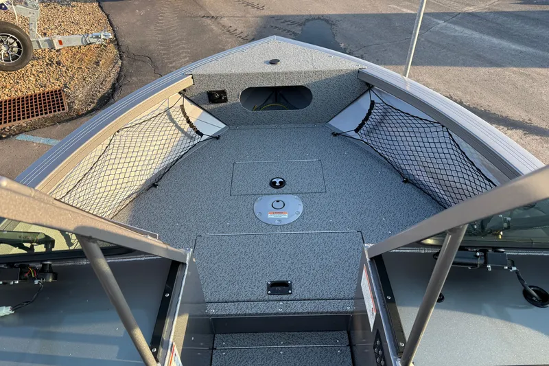 Slide: The Image of 2026 Crestliner 2050 Commander boat interior with storage nets and non-slip flooring. - 2