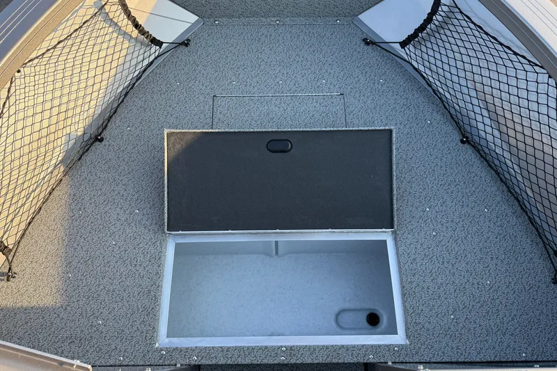 Slide: The Image of Crestliner 2050 Commander 2026 boat interior with storage compartment and netting. - 3