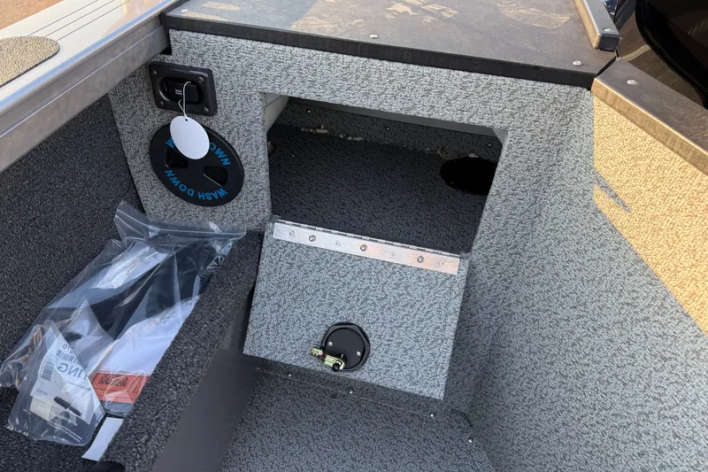 Slide: The Image of Interior of 2026 Crestliner 2050 Commander boat showing storage compartment and accessories. - 13