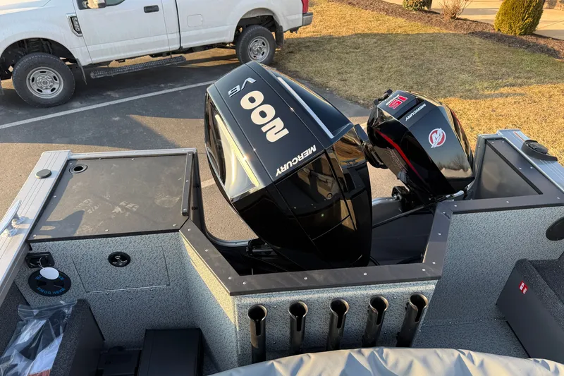 Slide: The Image of 2026 Crestliner 2050 Commander boat with Mercury outboard motors in a parking lot. - 14