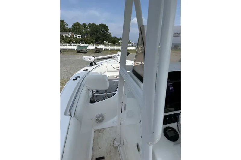 Slide: The Image of 2017 Sea Hunt Ultra 211 boat interior with white seating and control panel. - 7