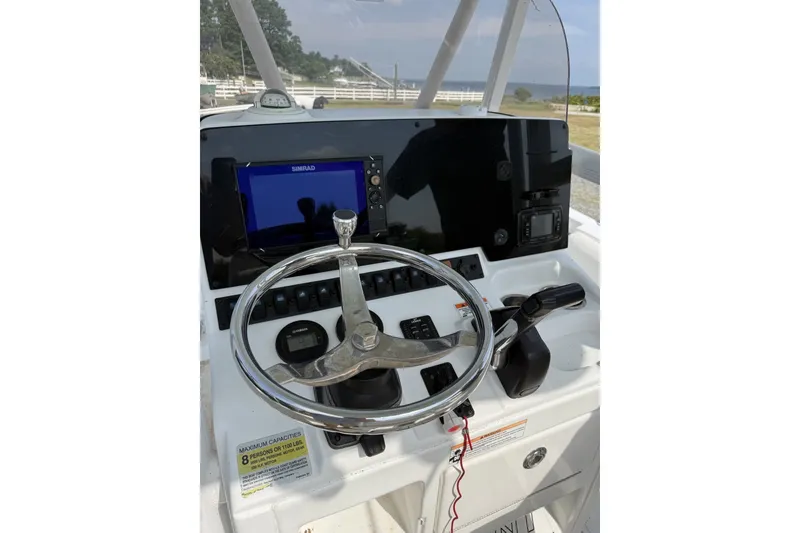Slide: The Image of 2017 Sea Hunt Ultra 211 boat dashboard with steering wheel and navigation system. - 5