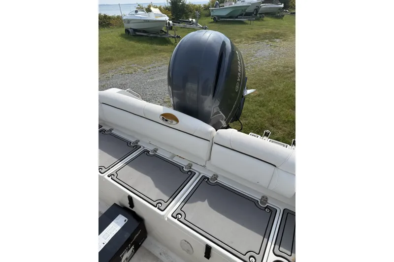 Slide: The Image of 2017 Sea Hunt Ultra 211 boat with Yamaha outboard motor, parked on grassy area. - 4