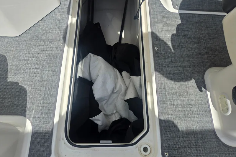Slide: The Image of Storage compartment on 2020 Bayliner DX 2250 boat with fabric inside. - 15