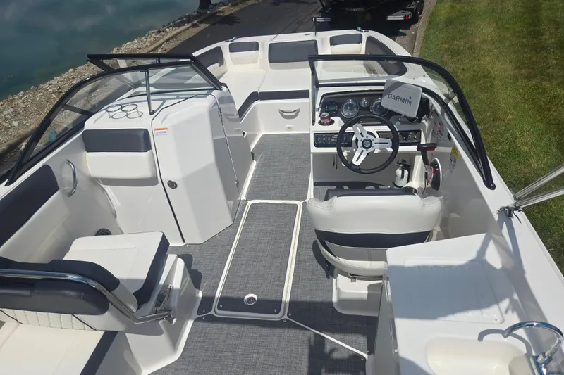 Slide: The Image of 2020 Bayliner DX 2250 boat interior with steering wheel, seating, and Garmin navigation system. - 11
