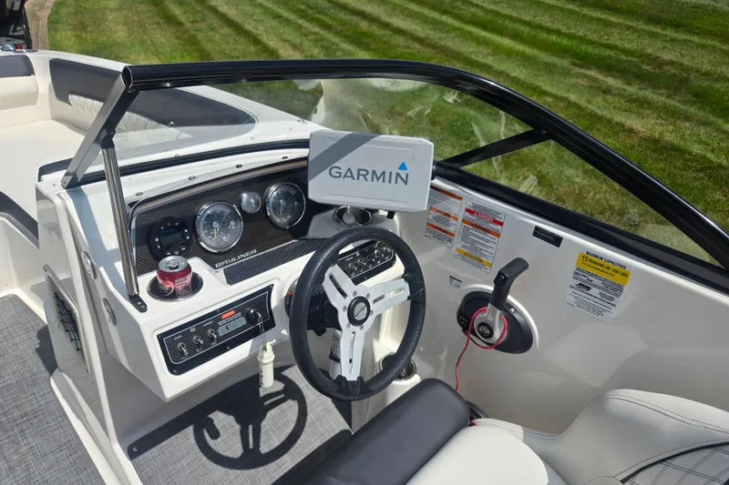 Slide: The Image of 2020 Bayliner DX 2250 boat dashboard with Garmin navigation system and steering wheel. - 16