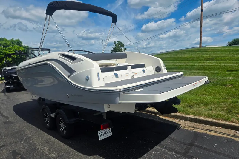 Slide: The Image of 2020 Bayliner DX 2250 boat on trailer, parked outdoors under a blue sky. - 3