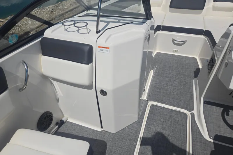 Slide: The Image of 2020 Bayliner DX 2250 boat interior with seating and storage compartments. - 13