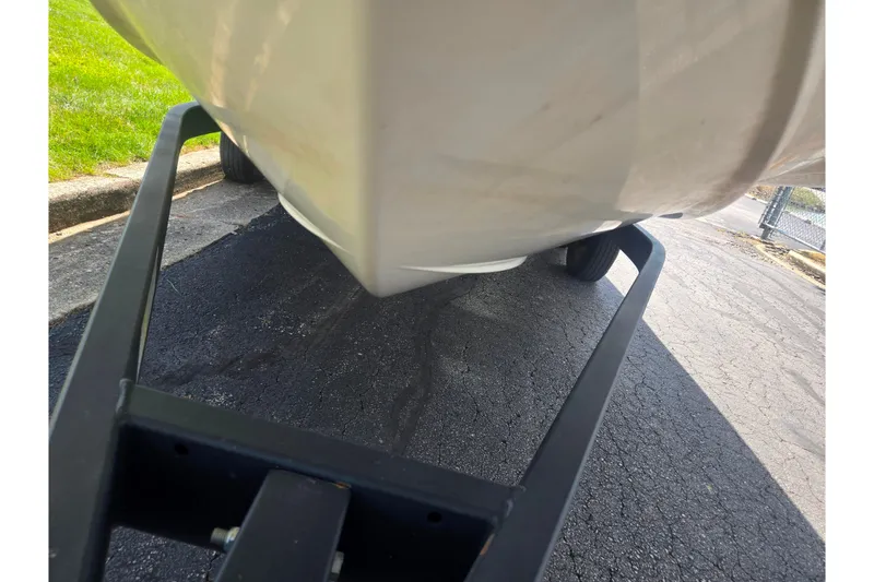 Slide: The Image of 2020 Bayliner DX 2250 boat on trailer, close-up view of hull and wheels. - 7