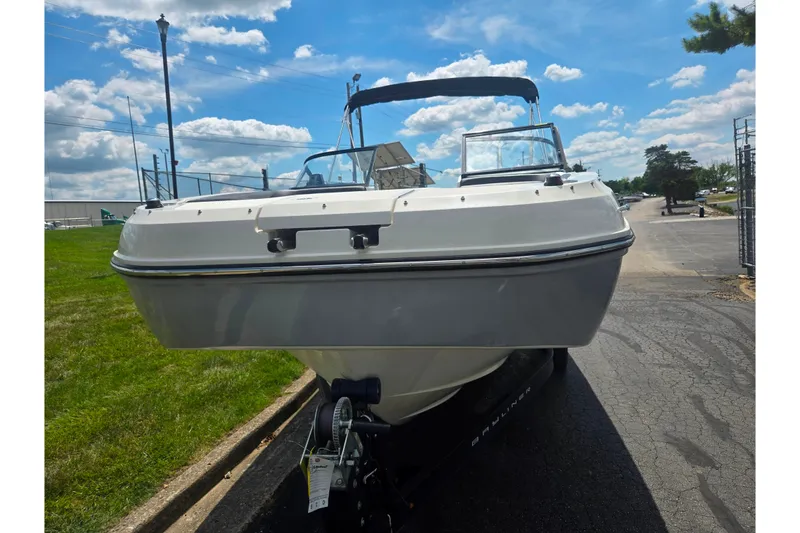 Slide: The Image of 2020 Bayliner DX 2250 boat on trailer under a clear blue sky. - 6