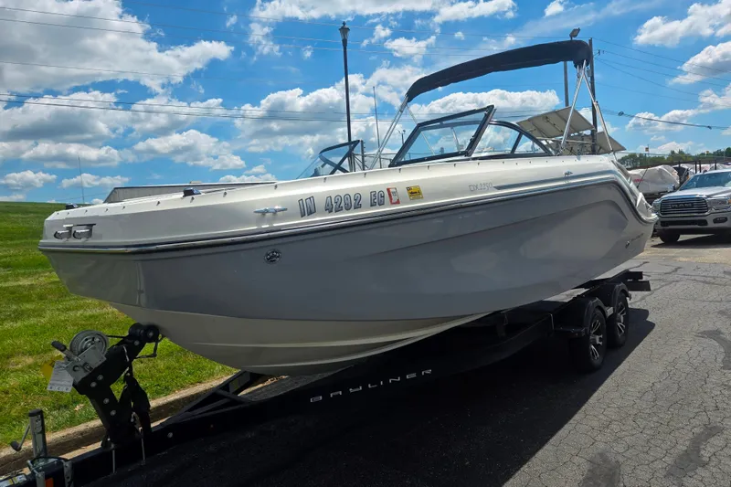 Slide: The Image of 2020 Bayliner DX 2250 boat on trailer under blue sky. - 5