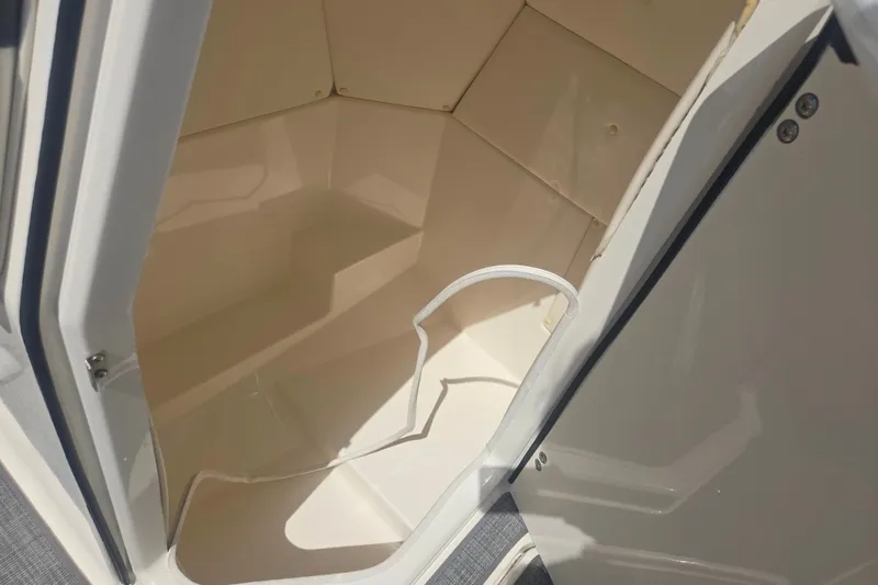 Slide: The Image of Interior storage compartment of 2020 Bayliner DX 2250 boat, open door view. - 14