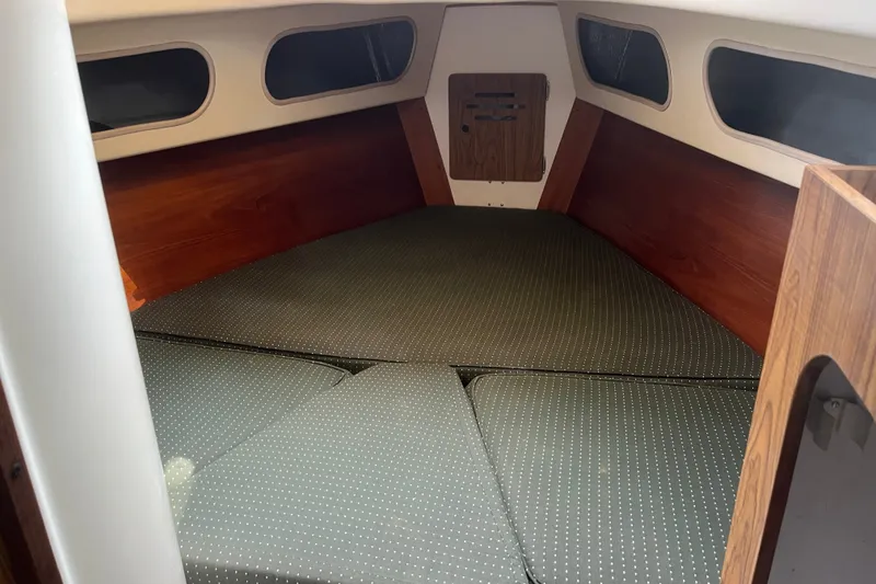 Slide: The Image of Interior cabin of a 1976 Pearson 10M sailboat with cushioned sleeping area. - 29
