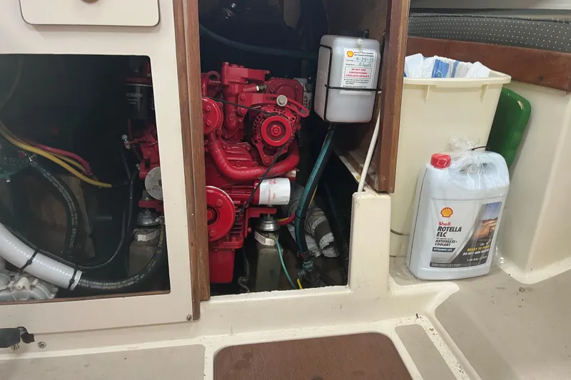 Slide: The Image of Engine compartment of a 1976 Pearson 10M sailboat with red engine and coolant container. - 31