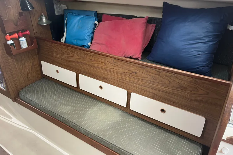 Slide: The Image of Interior of a 1976 Pearson 10M sailboat with cushions and storage drawers. - 26