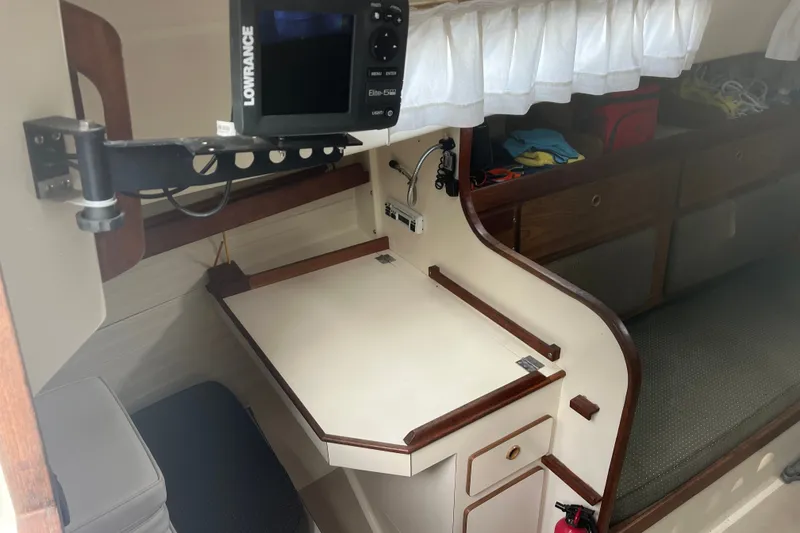Slide: The Image of Interior of a 1976 Pearson 10M sailboat with navigation equipment and cozy seating area. - 19
