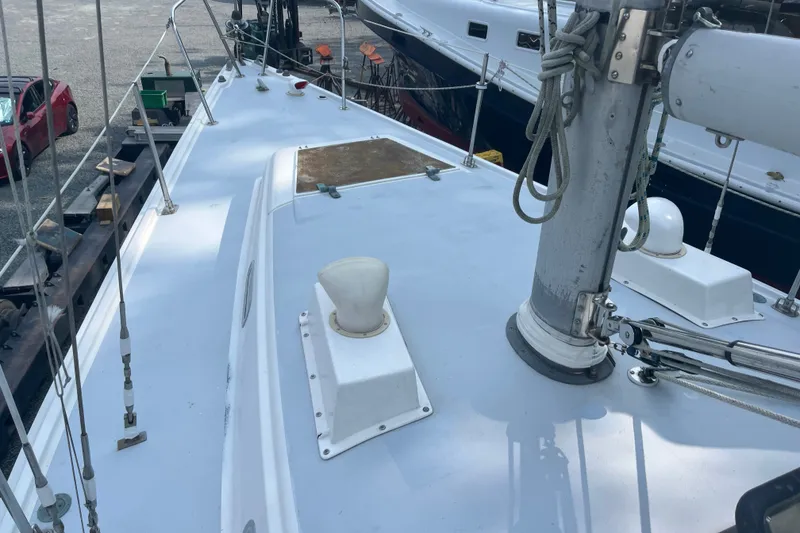 Slide: The Image of 1976 Pearson 10M sailboat deck with mast and fittings in a marina. - 14