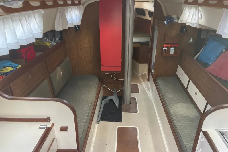 Slide: The Image of Interior of a 1976 Pearson 10M sailboat with wooden furnishings and seating. - 18
