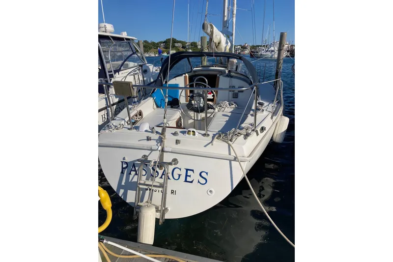 Slide: The Image of 1976 Pearson 10M sailboat docked in marina, rear view with clear sky. - 39