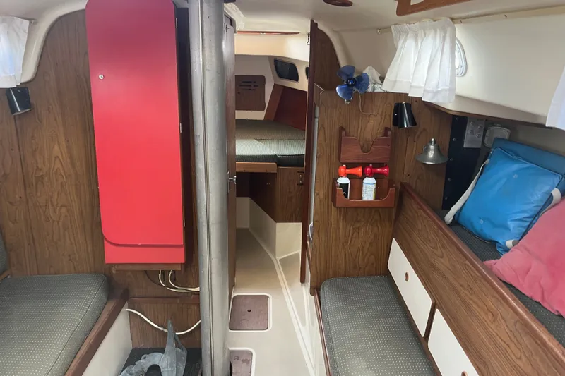 Slide: The Image of Interior of a 1976 Pearson 10M sailboat with wood paneling and cozy seating. - 27