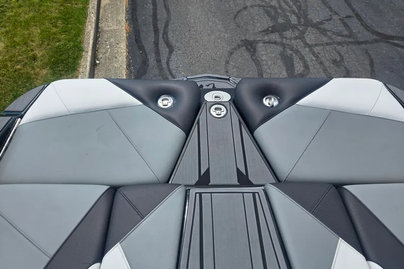 Slide: The Image of 2025 Centurion Nv233 boat deck with sleek, modern design and gray upholstery. - 18