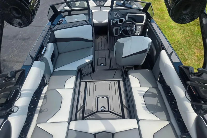 Slide: The Image of Interior of 2025 Centurion Nv233 boat, featuring sleek seating and modern dashboard design. - 23