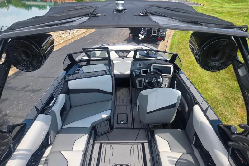 Slide: The Image of Interior view of 2025 Centurion Nv233 boat with modern seating and dashboard. - 24