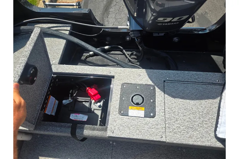 Slide: The Image of 2023 Alumacraft Competitor 165 Sport boat battery compartment with Yamaha 90 engine. - 24