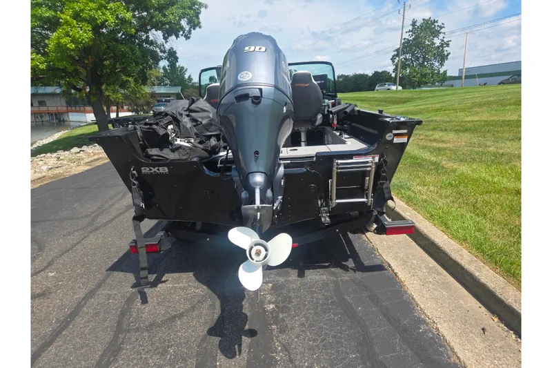 Slide: The Image of 2023 Alumacraft Competitor 165 Sport boat with outboard motor on trailer. - 2