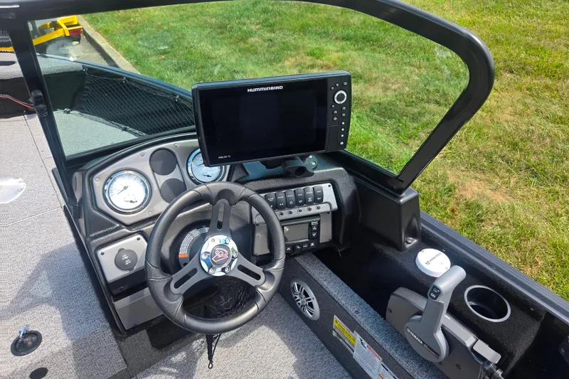 Slide: The Image of 2023 Alumacraft Competitor 165 Sport dashboard with steering wheel and Humminbird Helix 10 display. - 12