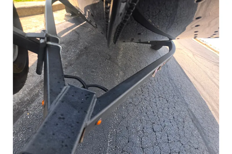 Slide: The Image of 2023 Alumacraft Competitor 165 Sport boat trailer on asphalt road. - 8