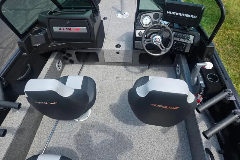 Slide: The Image of 2023 Alumacraft Competitor 165 Sport boat interior with steering wheel and seating. - 11