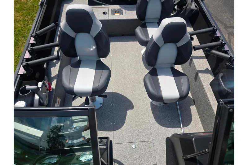 Slide: The Image of 2023 Alumacraft Competitor 165 Sport interior with four seats and rod holders. - 21