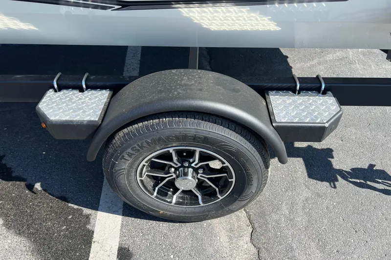 Slide: The Image of Trailer wheel and fender of 2026 Crestliner XF 189 boat on pavement. - 13