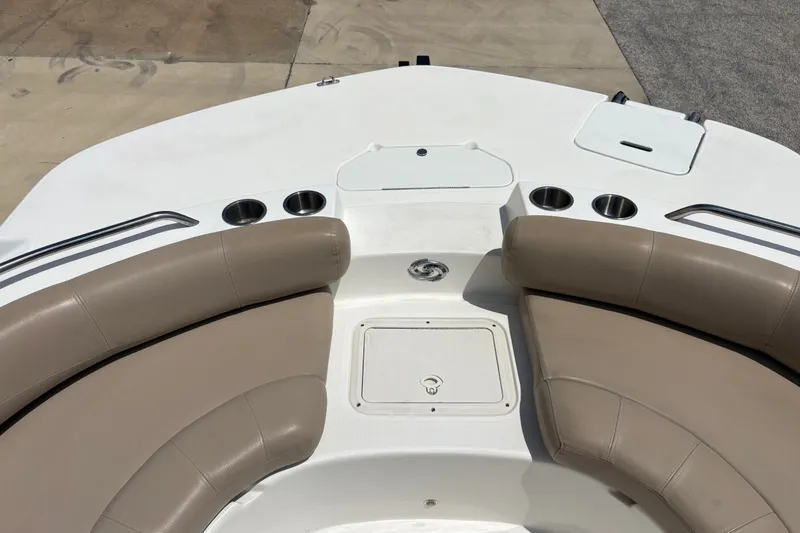 Slide: The Image of 2022 Hurricane SunDeck Sport 201 OB boat interior with beige seating and cup holders. - 20