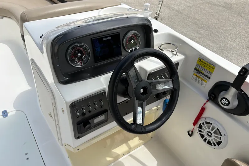 Slide: The Image of Steering console of 2022 Hurricane SunDeck Sport 201 OB boat with gauges and controls. - 28