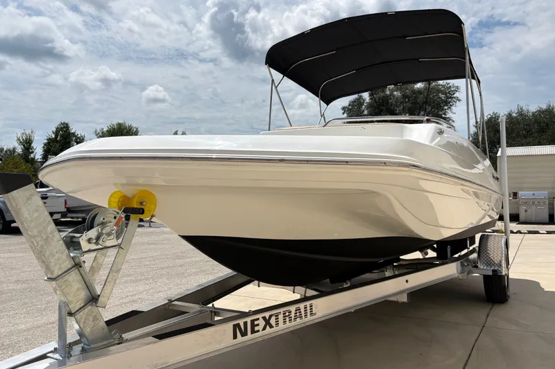 Slide: The Image of 2022 Hurricane SunDeck Sport 201 OB boat on trailer under cloudy sky. - 14
