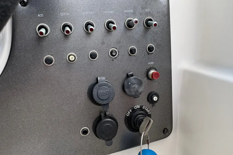 Slide: The Image of Control panel of 2022 Hurricane SunDeck Sport 201 OB boat with switches and USB ports. - 31