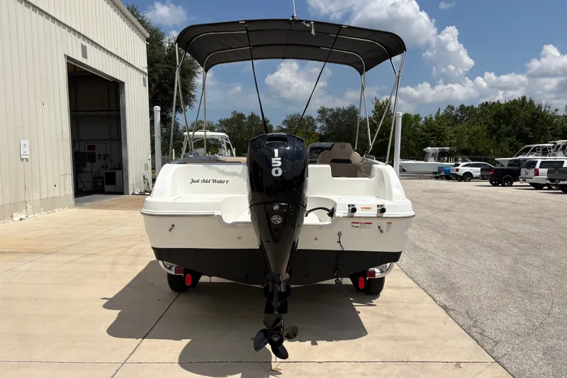Slide: The Image of 2022 Hurricane SunDeck Sport 201 OB boat with outboard motor, parked outdoors. - 7