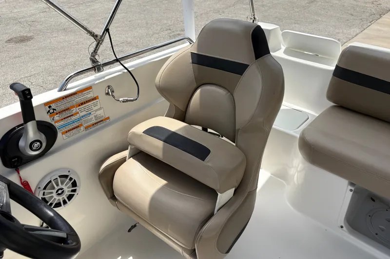 Slide: The Image of Captain's seat on 2022 Hurricane SunDeck Sport 201 OB boat, featuring beige upholstery. - 27