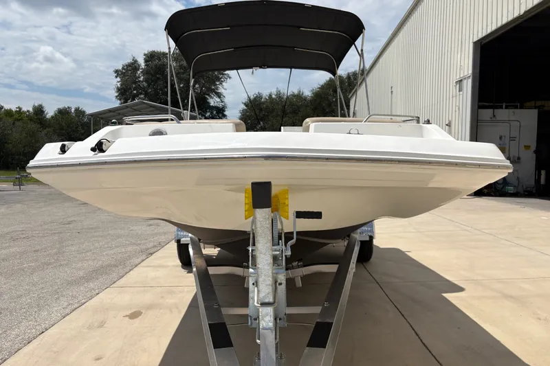 Slide: The Image of 2022 Hurricane SunDeck Sport 201 OB boat on trailer, outdoor setting. - 12