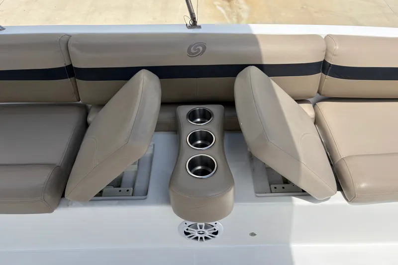 Slide: The Image of 2022 Hurricane SunDeck Sport 201 OB boat seating with cup holders and beige upholstery. - 25