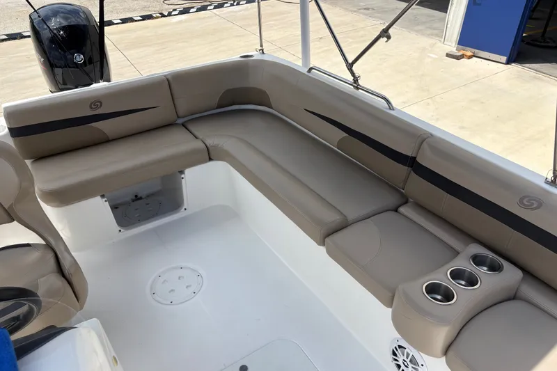 Slide: The Image of 2022 Hurricane SunDeck Sport 201 OB boat interior with beige seating and cup holders. - 23