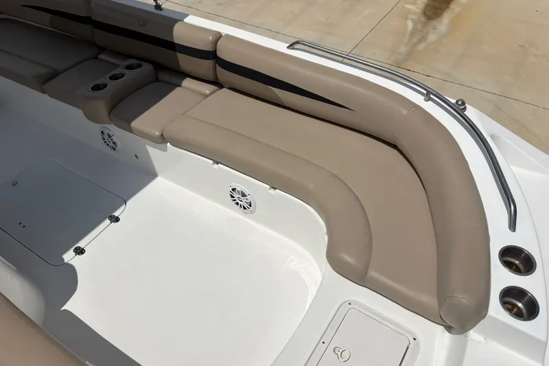 Slide: The Image of 2022 Hurricane SunDeck Sport 201 OB boat interior with beige seating and cup holders. - 21