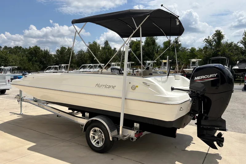Slide: The Image of 2022 Hurricane SunDeck Sport 201 OB boat with Mercury outboard motor on trailer. - 6