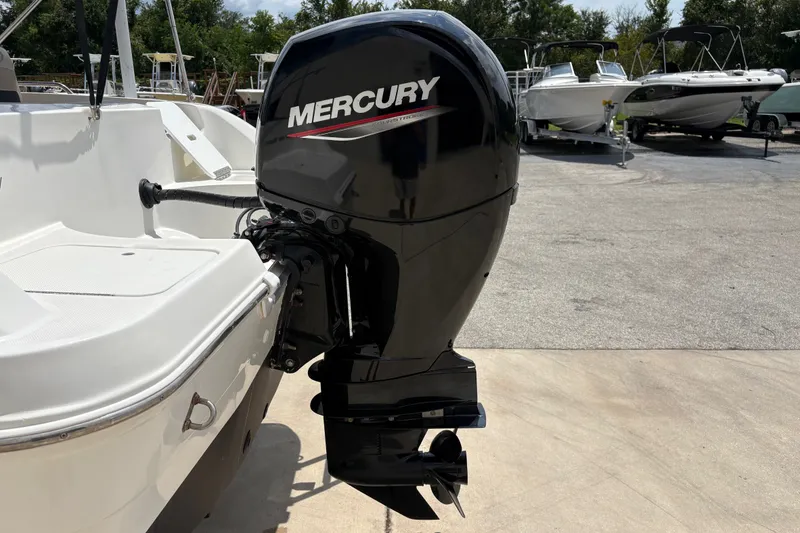 Slide: The Image of 2022 Hurricane SunDeck Sport 201 OB with Mercury outboard motor in a marina setting. - 10